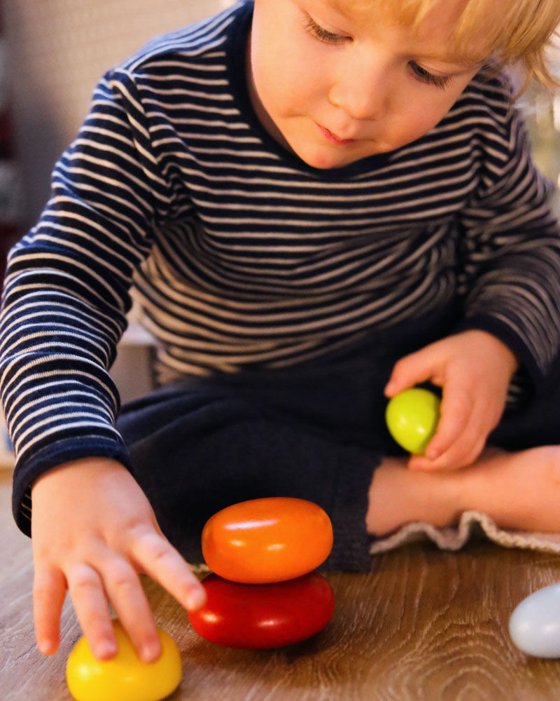 Kind met wiebelstenen houten speelgoed van Selecta